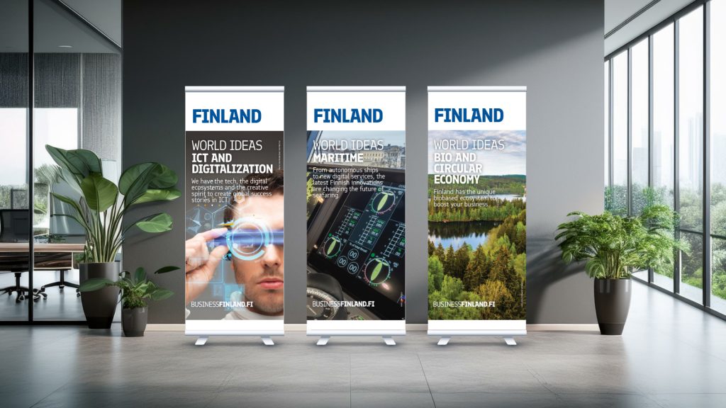 Three rollups against a dark wall in an office space.